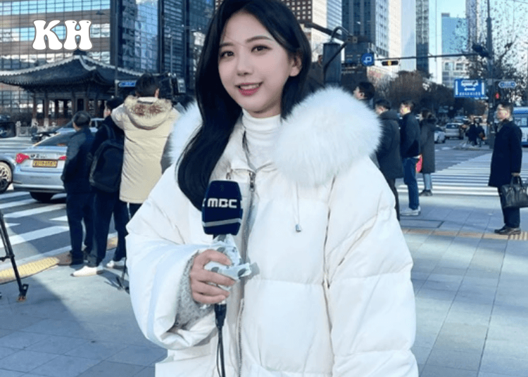 a woman in a white coat holding a microphone